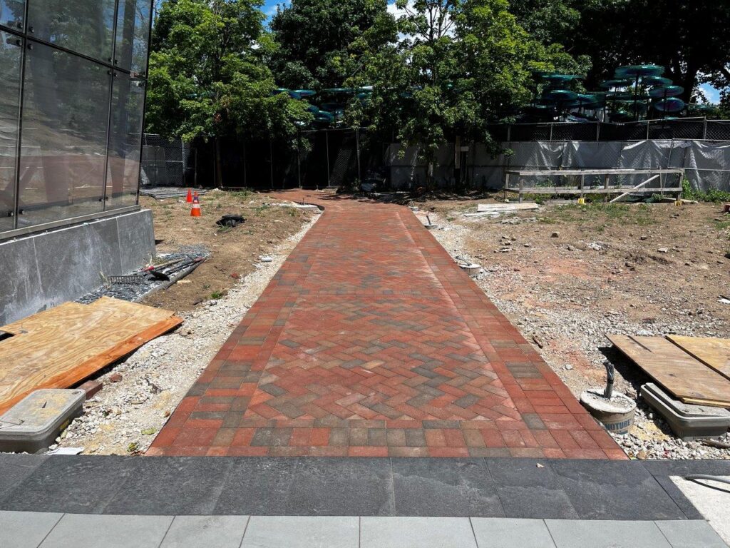Brick pavers have been placed and compacted for a new park brick walkway leading to the station.